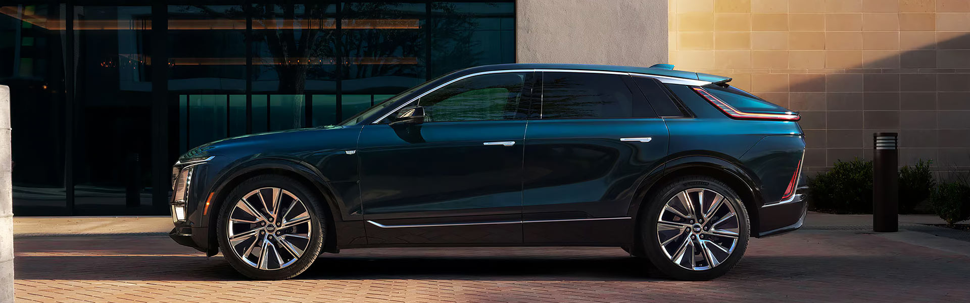 2025 Cadillac Lyriq EV SUV is parked beside a modern building
