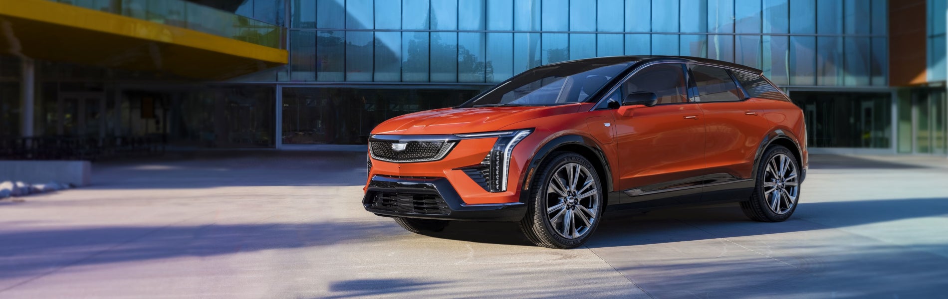 2025 Cadillac Optiq parked in front of an office building