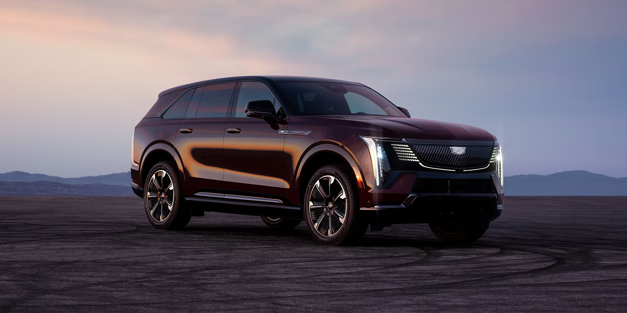 2026 Cadillac Escalade IQ luxury EV with illuminated front grille and sleek aerodynamic exterior.