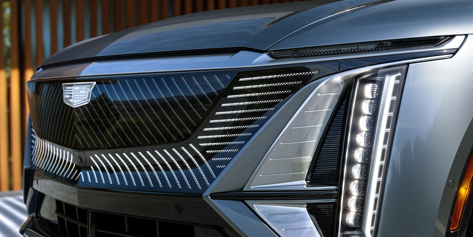 Close-up of SUV front grille and headlights.