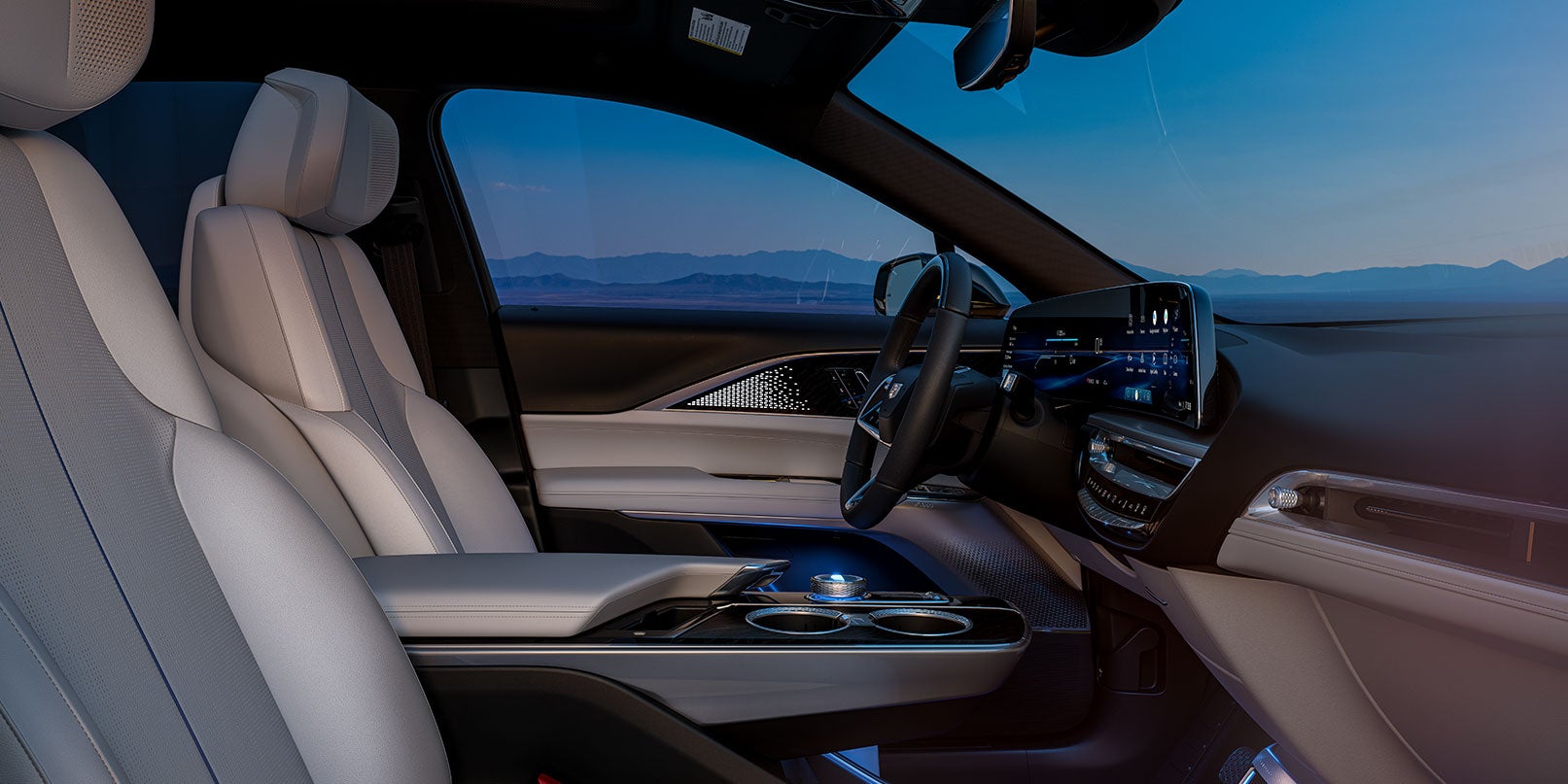 Front seats and dashboard of a luxury SUV interior at sunset.