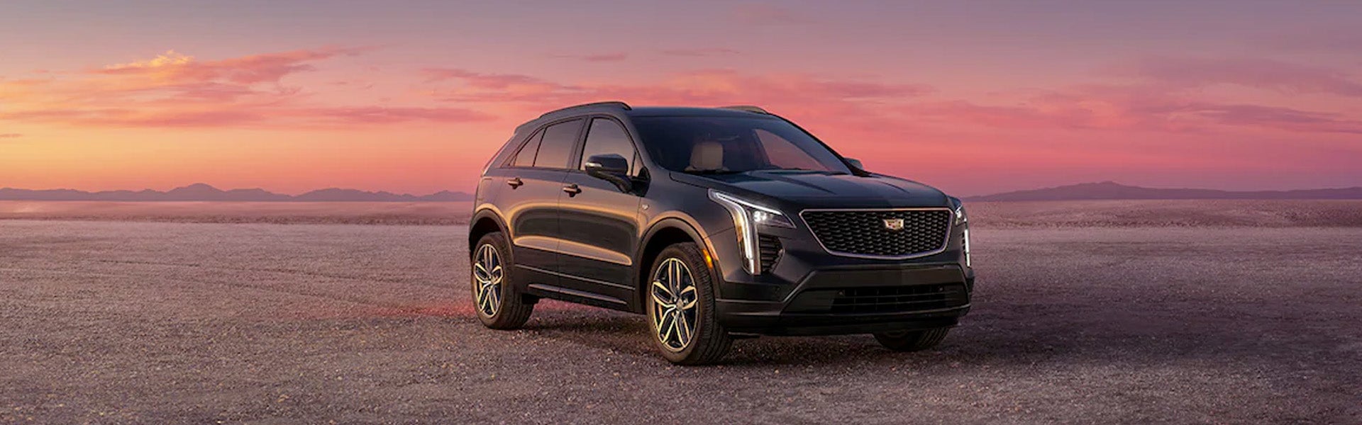 XT4 stands parked on open ground showcasing its bold and dynamic front view